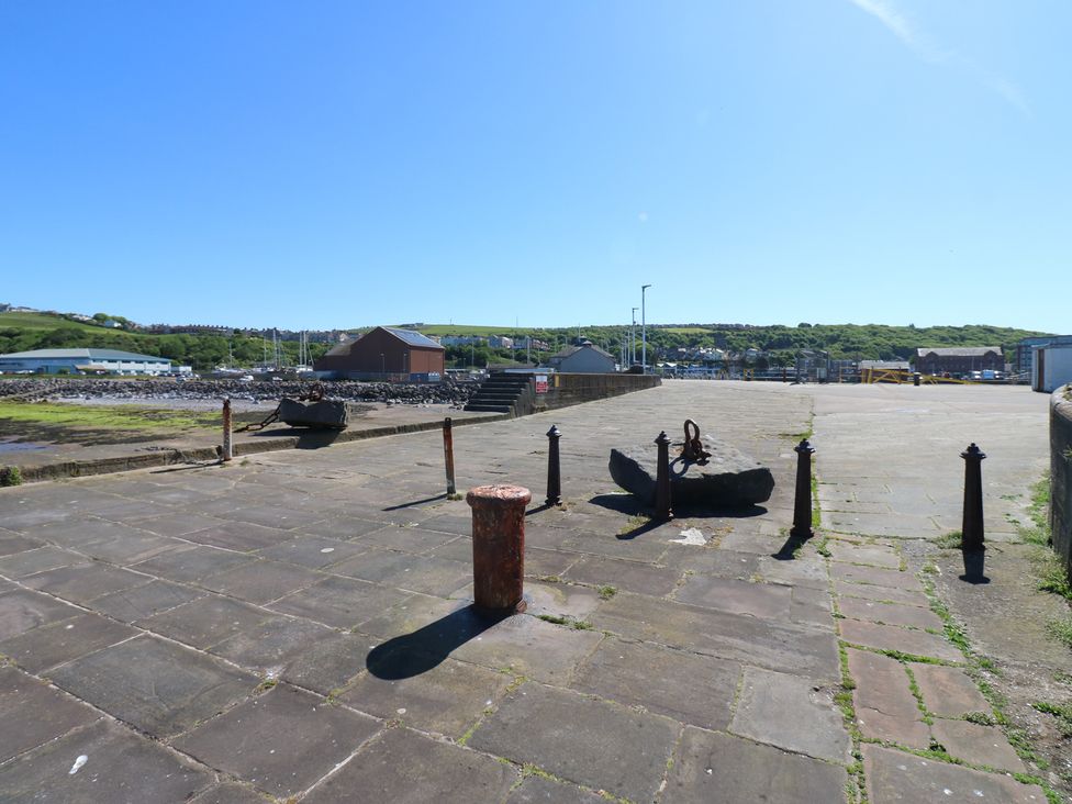 An outdoor area with an anchor and bollards at Harbour View in Whitehaven
