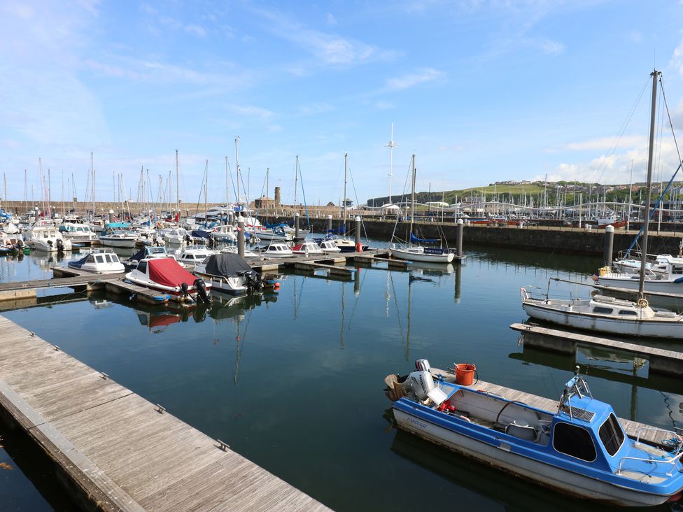 A marina with various boats moored at Harbour View in Whitehaven