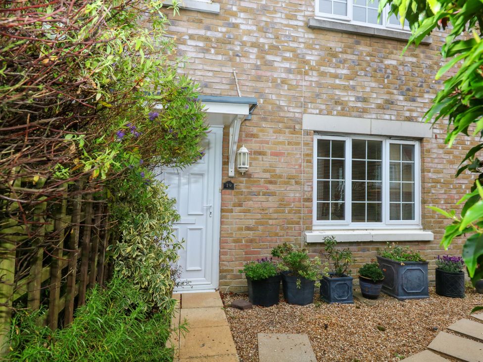 An outdoor area with a door and plants at Fairways House Weymouth