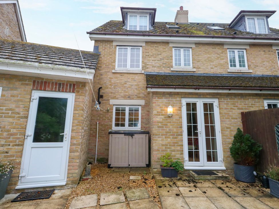 An outdoor area with a door and windows at Fairways House in Weymouth