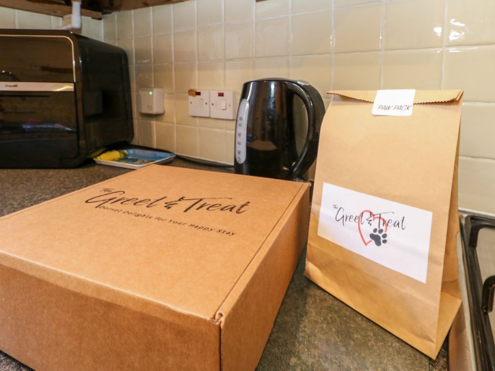 A kitchen with a box and a brown paper bag at Fairways House in Weymouth