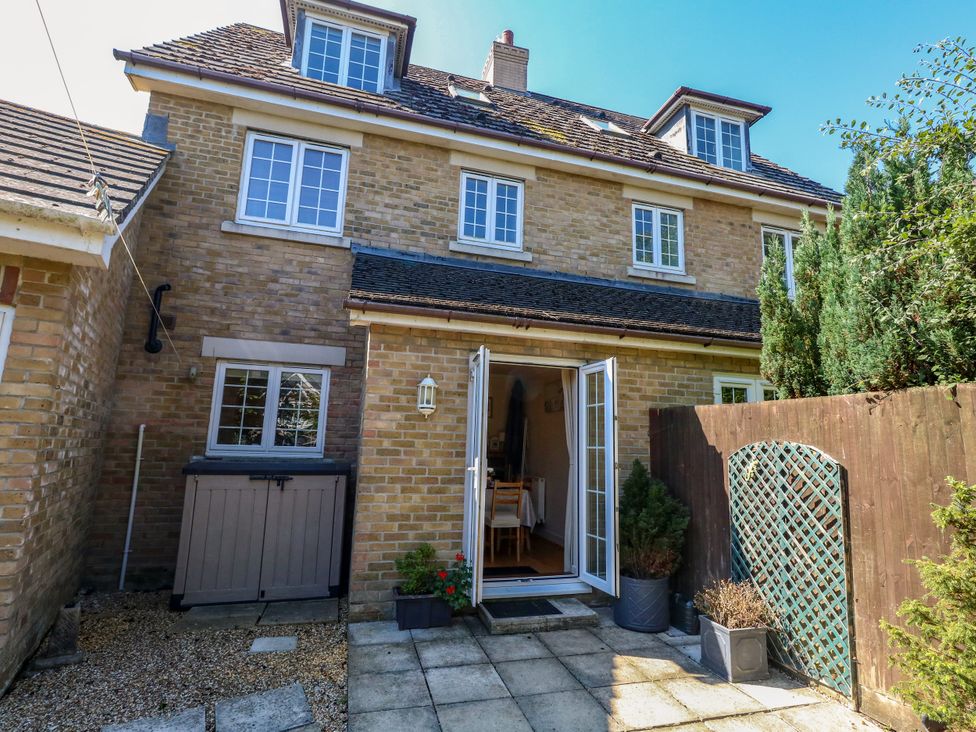 An outdoor view of a house with a garden area at Fairways House in Weymouth