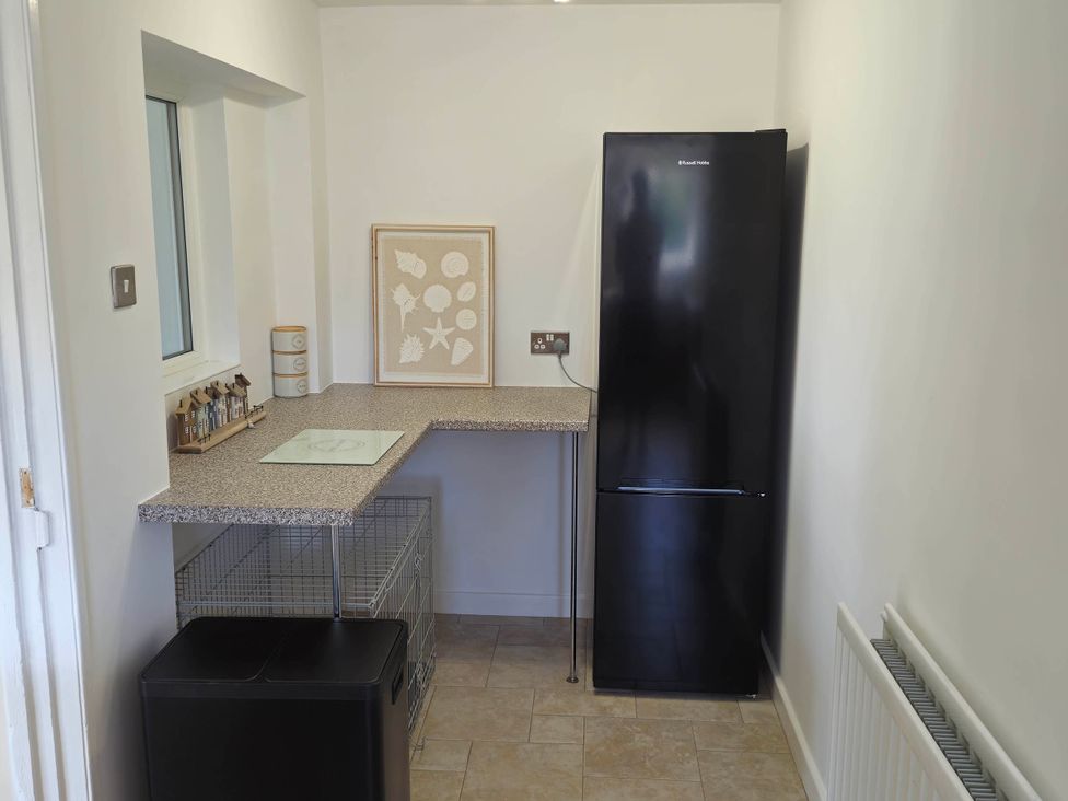 A kitchen with a refrigerator and counter space at 13 Seafield Road