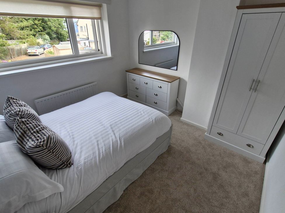 A bedroom with a bed and dresser at 13 Seafield Road