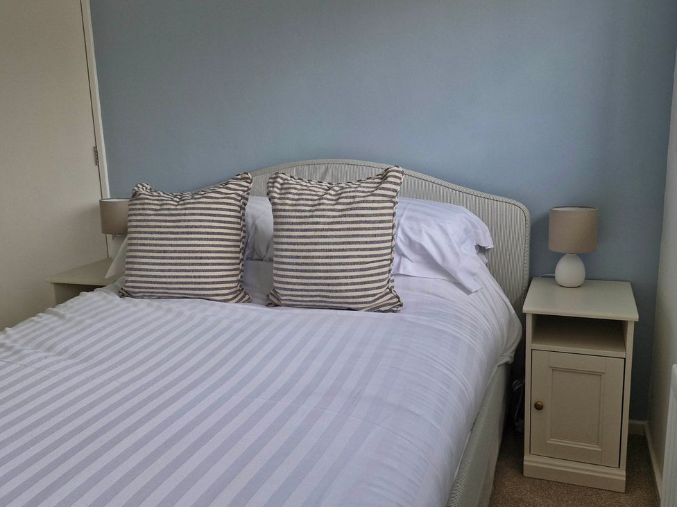 A bedroom with a bed and nightstand at 13 Seafield Road