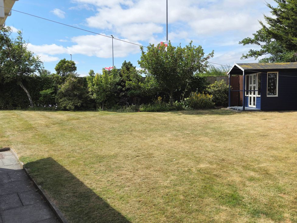 A garden with a shed and trees at 13 Seafield Road 