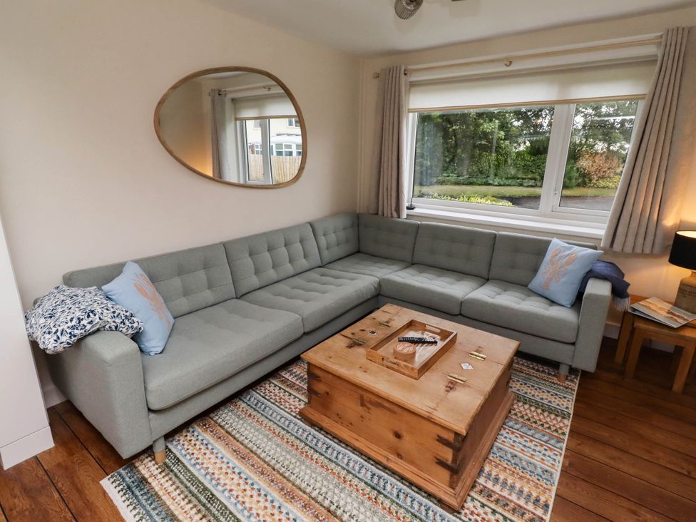 A living room with a sofa and coffee table at Bari House in Seahouses