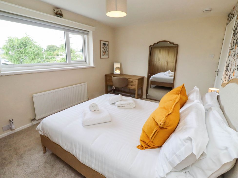 A bedroom with a double bed and a desk at Bari House in Seahouses