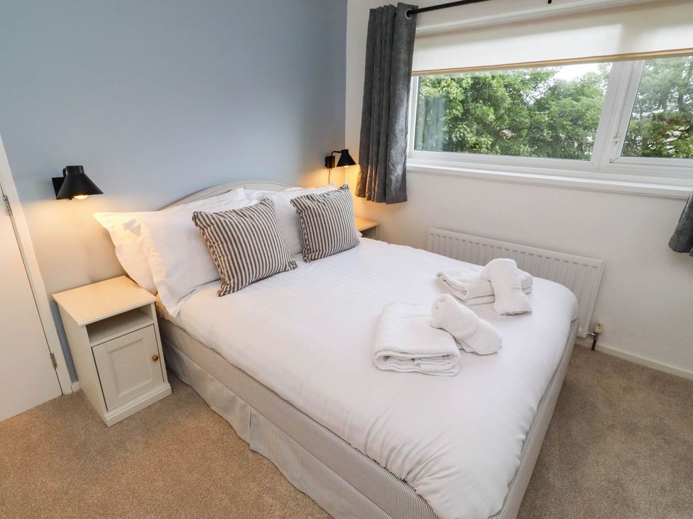 A bedroom with a bed and bedside table at Bari House in Seahouses