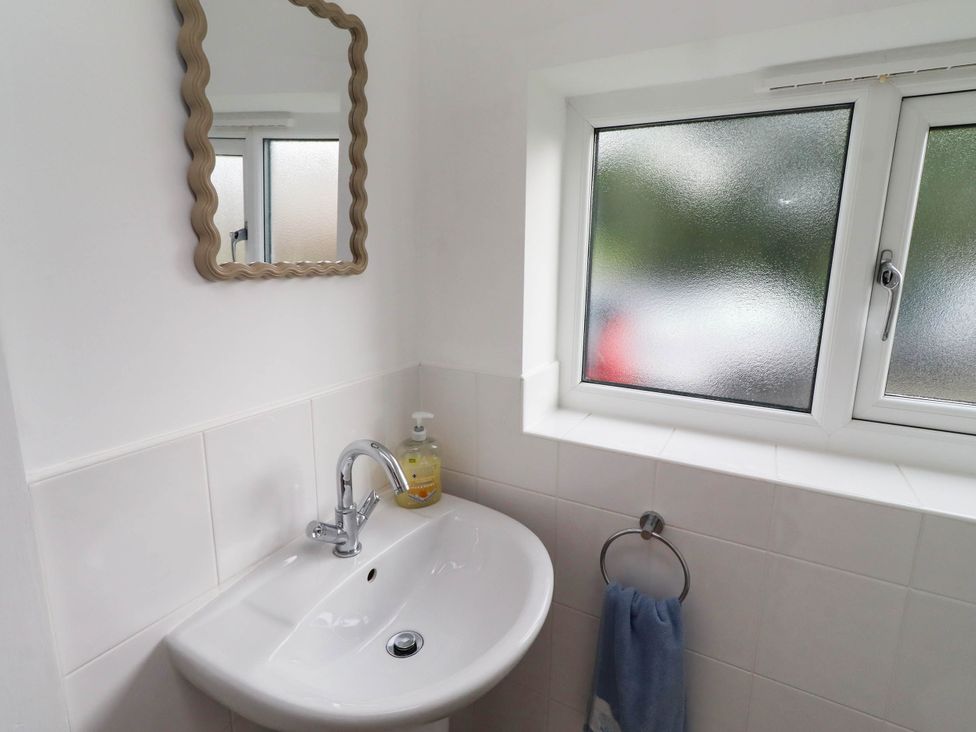 A bathroom with a sink and mirror at Bari House in Seahouses