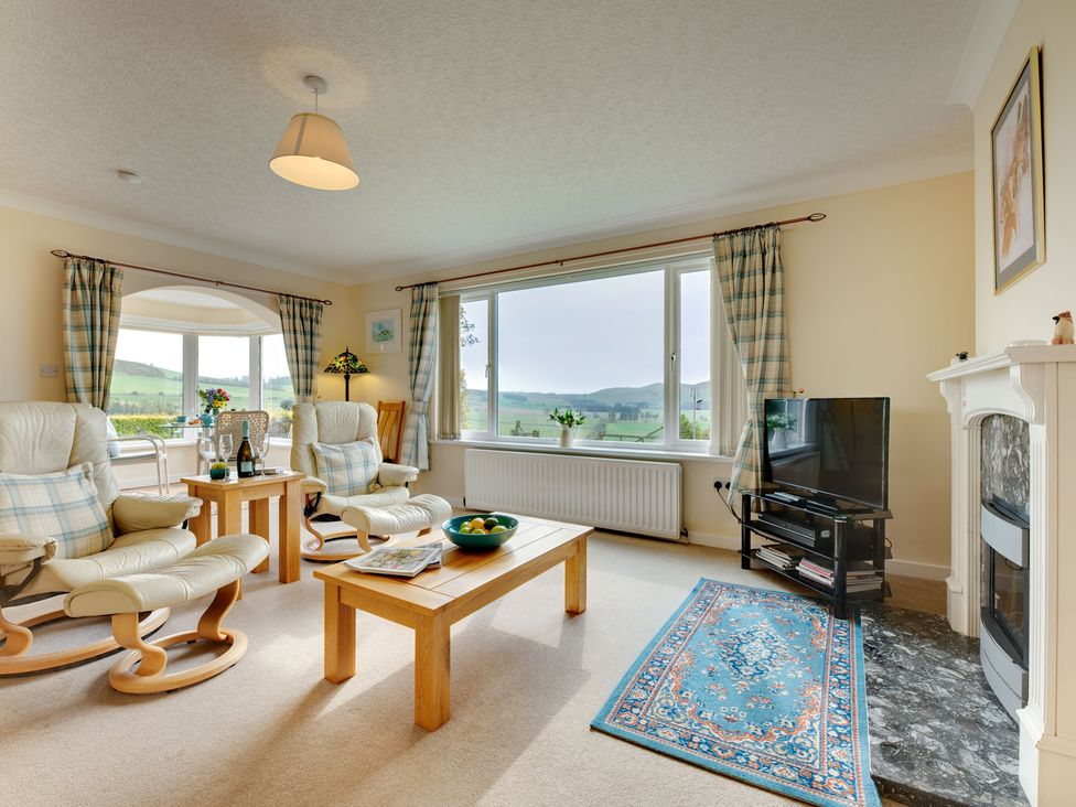 A living room with two armchairs and a coffee table at The Granary in Alnwick