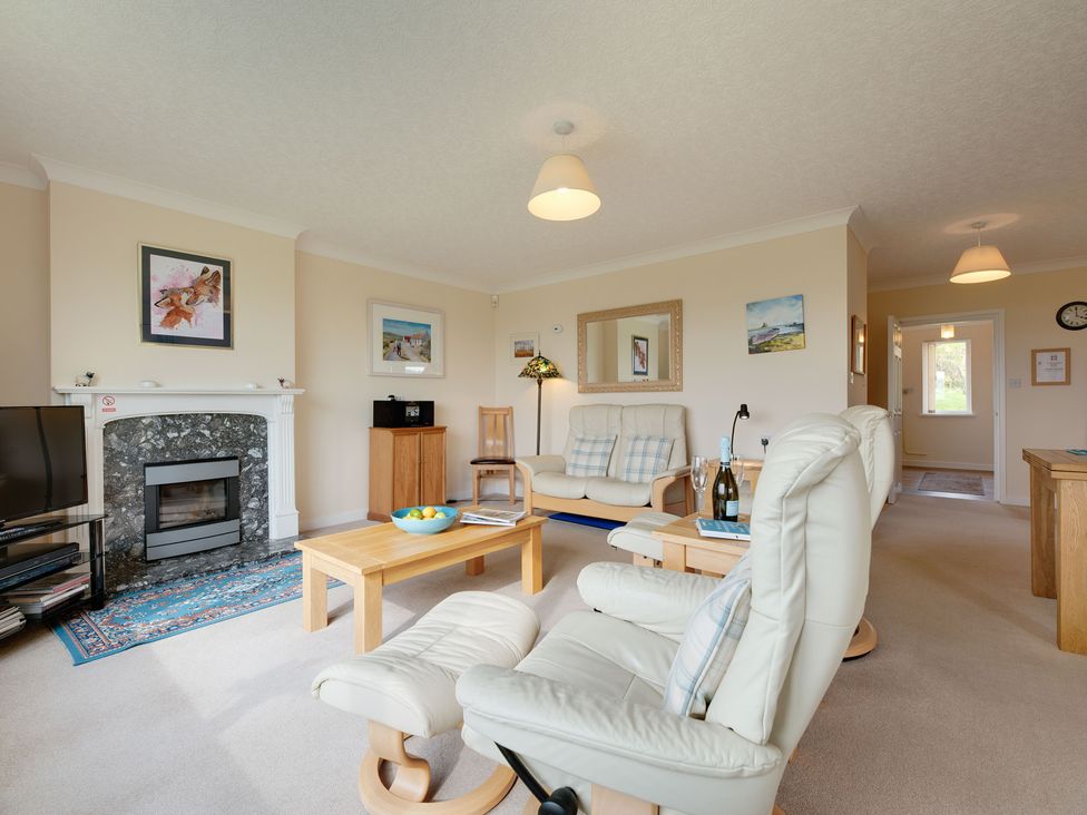 A living room with a sofa and television at The Granary in Alnwick
