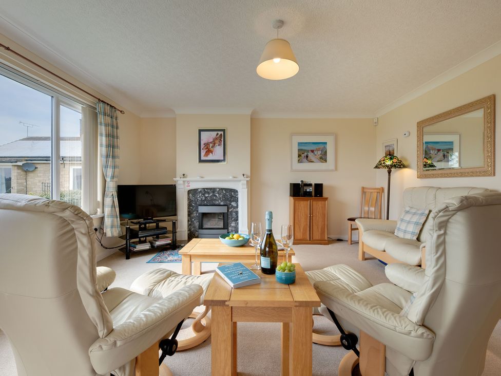 A living room with a television and coffee table at The Granary in Alnwick