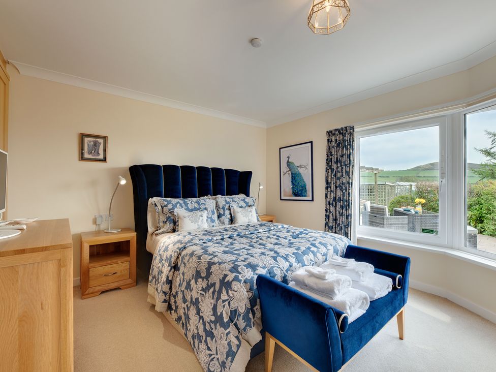 A bedroom with a bed and window at The Granary in Alnwick