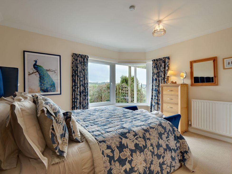 A bedroom with a bed and a dresser at The Granary in Alnwick