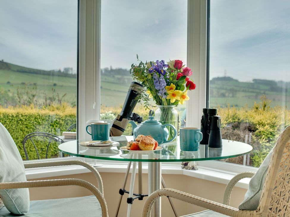 A conservatory with a table set for tea at The Granary in Alnwick