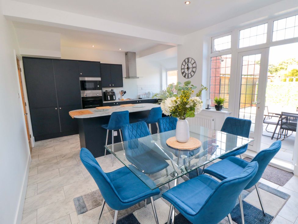A dining room with a table and chairs at 60 Muston Road in Filey