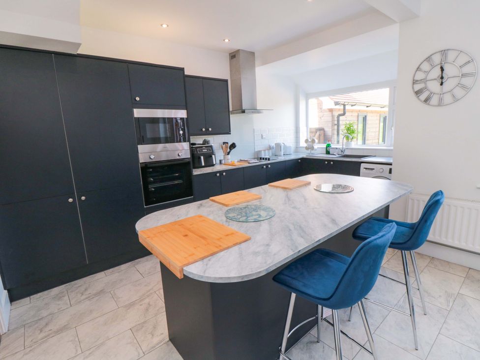 A kitchen with cabinets and appliances at 60 Muston Road in Filey
