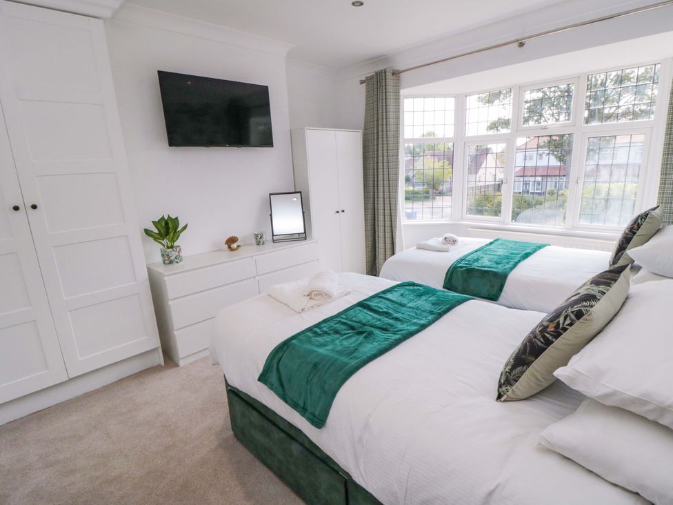 A bedroom with two beds and a television at 60 Muston Road in Filey