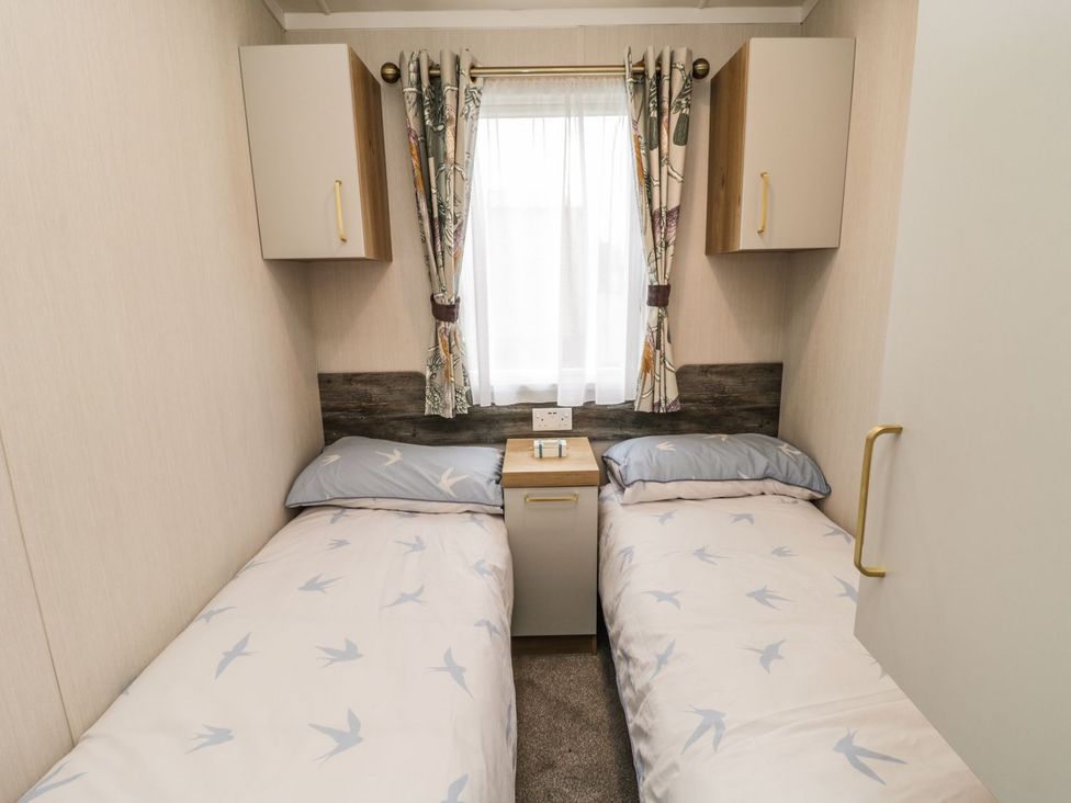 A bedroom with two single beds and a nightstand at Kelly's Retreat in Scarborough