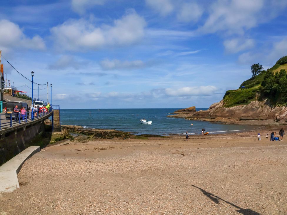 A beach with people and boats at Seacroft in Combe Martin