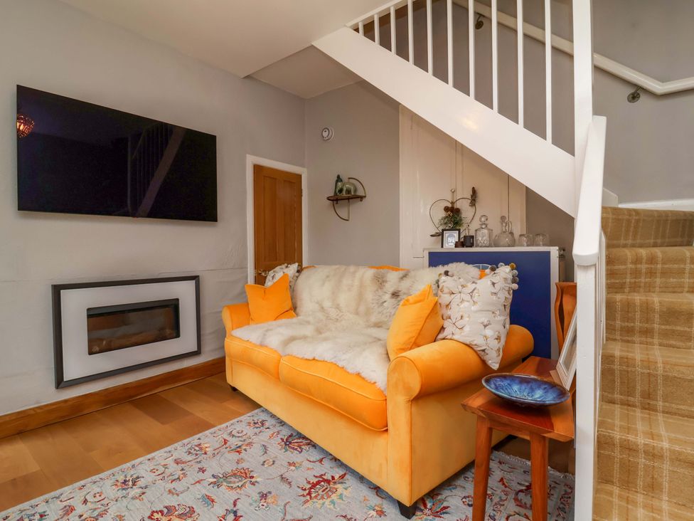A living room with a sofa and television at Seacroft in Combe Martin