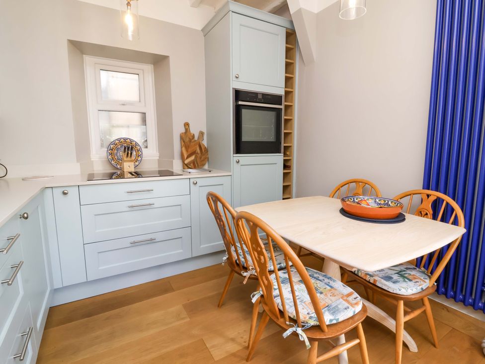 A kitchen with a dining table and chairs at Seacroft in Combe Martin