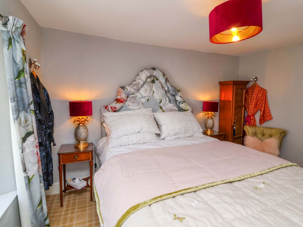 A bedroom with a bed and bedside table at Seacroft in Combe Martin