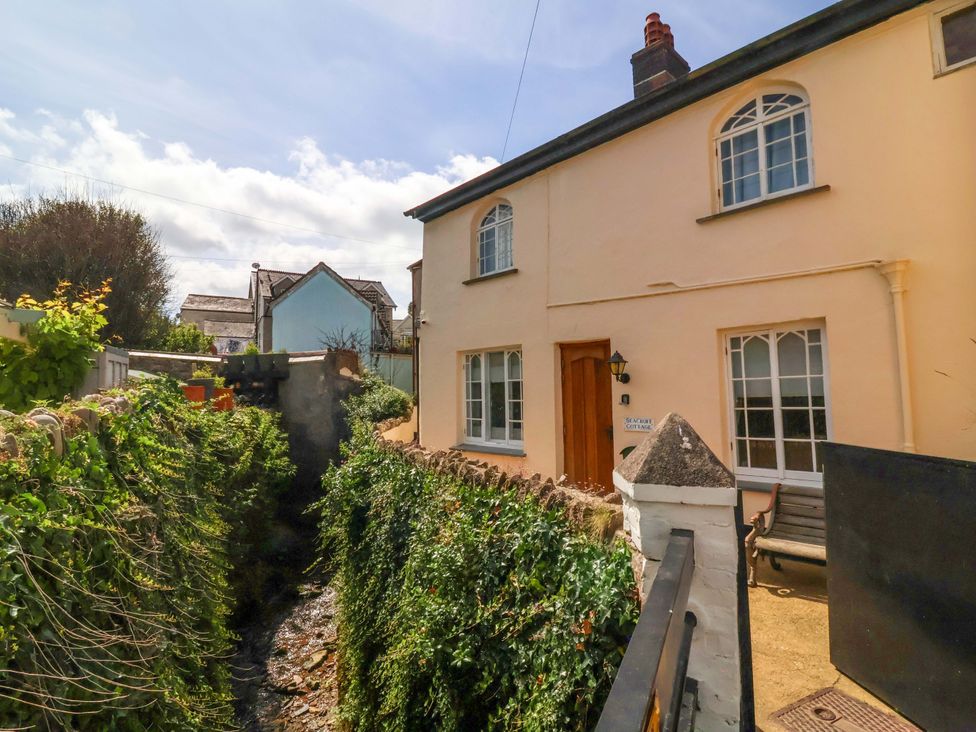 A house with a pathway and stream in front at Seacroft in Combe Martin