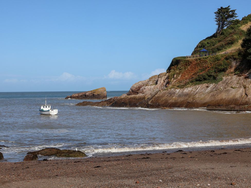 A boat near the shore and cliffs at Seacroft Cottage Combe Martin