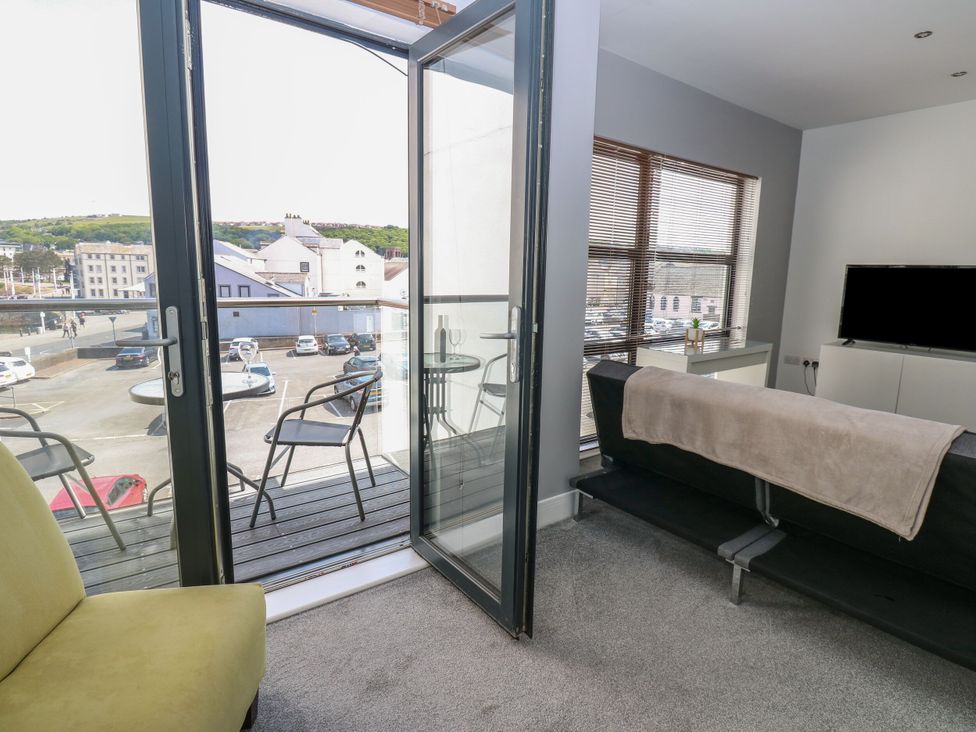 A living room with a sofa and television at Harbourside Apartments in Whitehaven