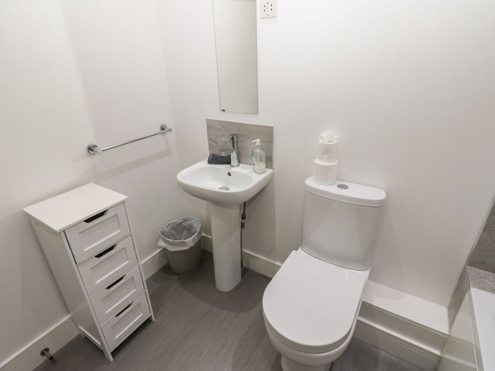 A bathroom with a toilet and sink at Harbourside Apartments in Whitehaven