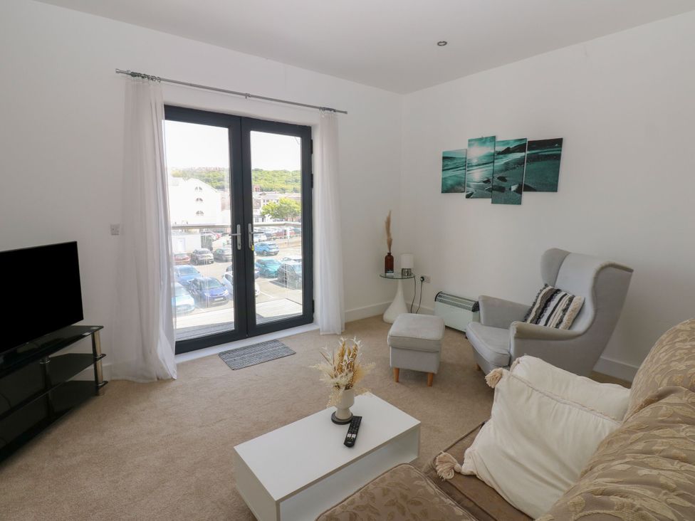 A living room with a sofa and a TV at Seaview in Whitehaven
