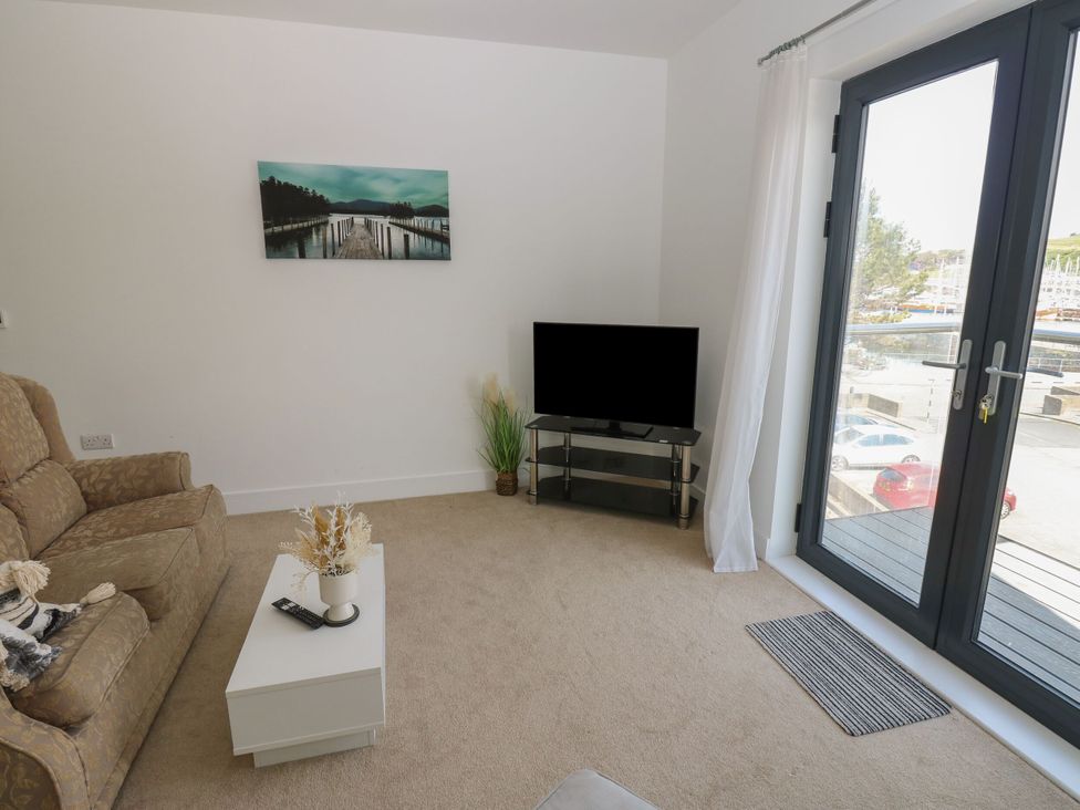 A living room with a sofa and television at Seaview in Whitehaven