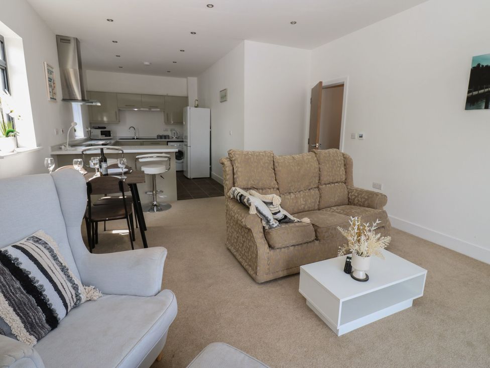 A living room with a sofa and dining table at Seaview in Whitehaven
