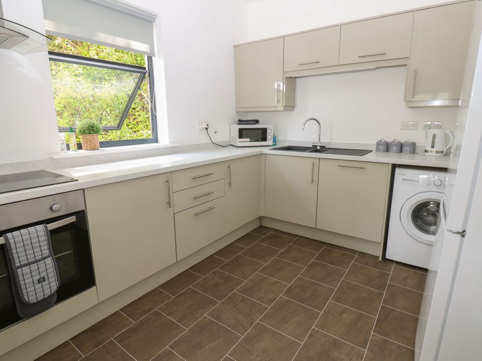 A kitchen with appliances and a window at Seaview in Whitehaven