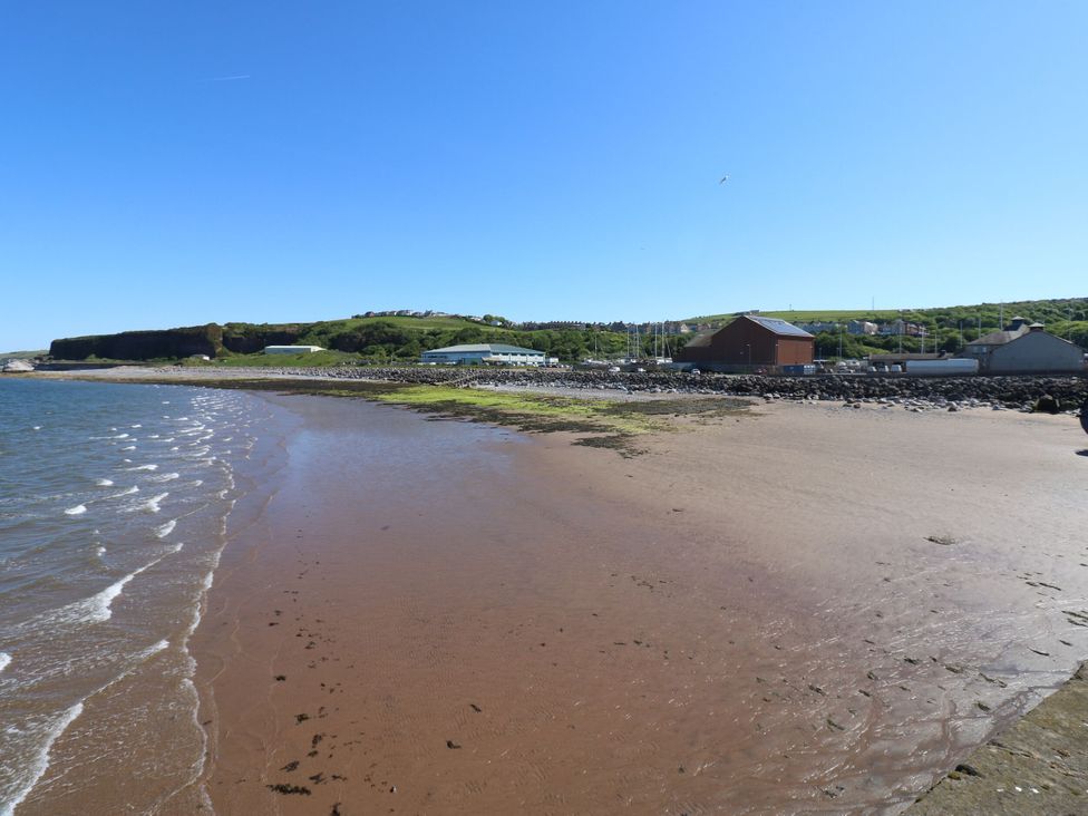 A beach with water and cliffs at Seaview in Whitehaven
