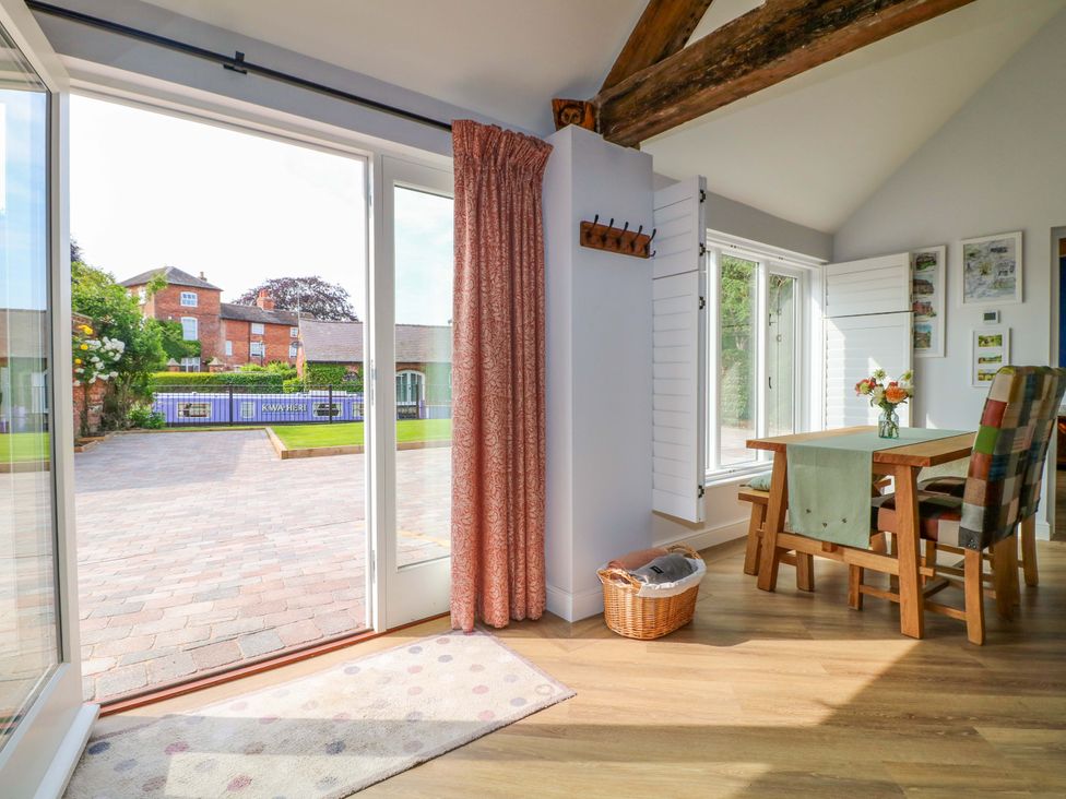 A dining room with a table and chairs at The Canalside Cottage in Derby