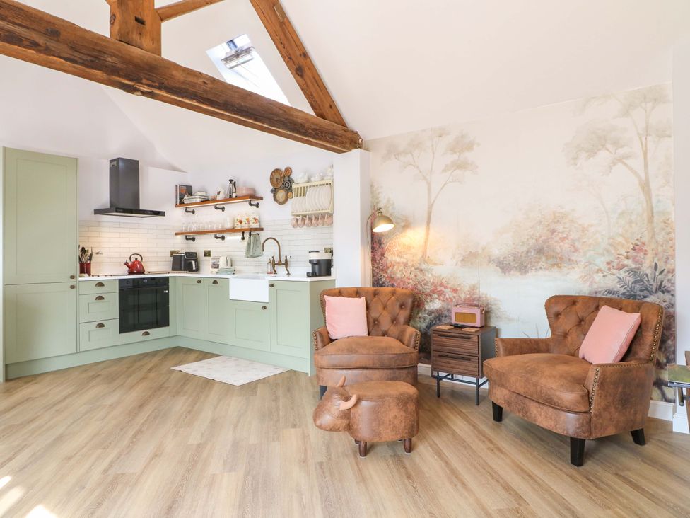 A kitchen and living area with furniture and appliances at The Canalside Cottage in Derby