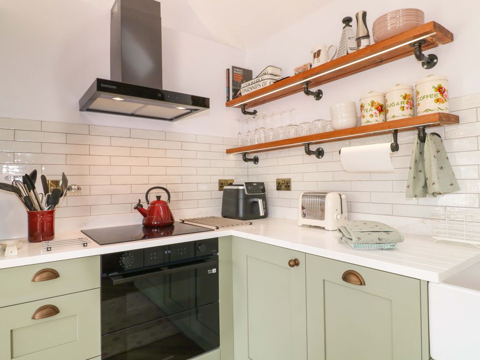 A kitchen with a kettle, toaster, and utensils at The Canalside Cottage in Derby