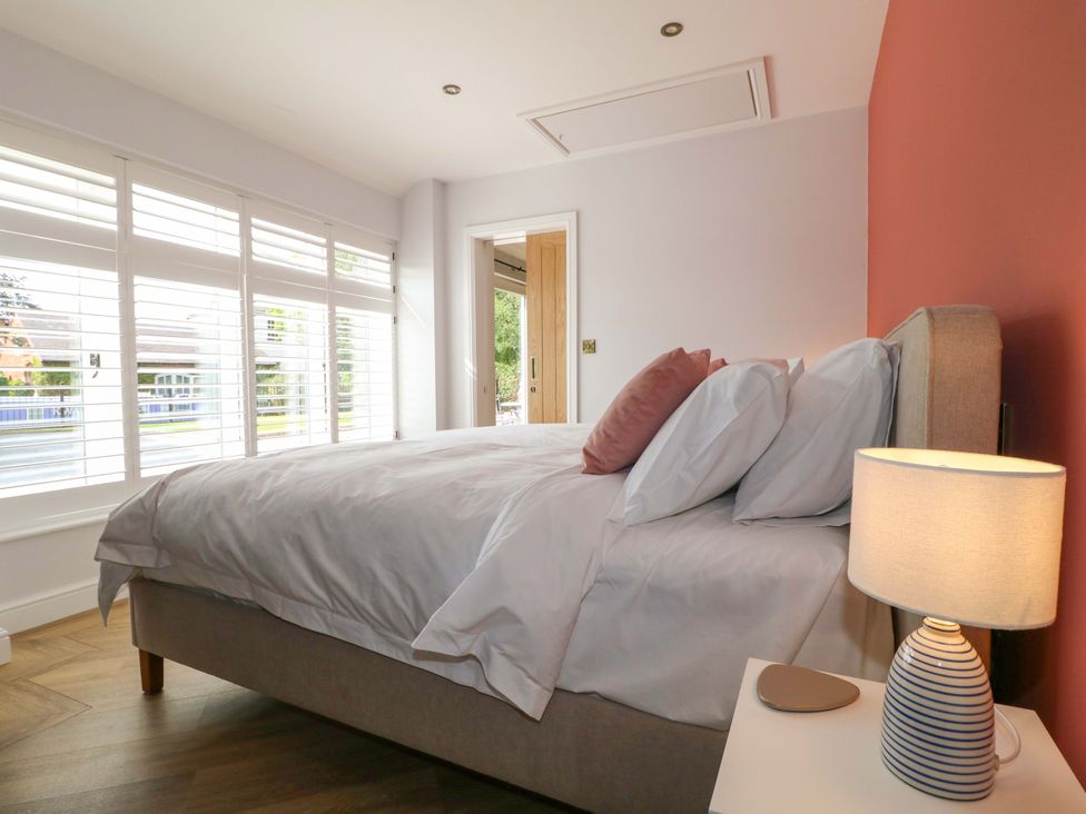 A bedroom with a bed and lamp at The Canalside Cottage in Derby