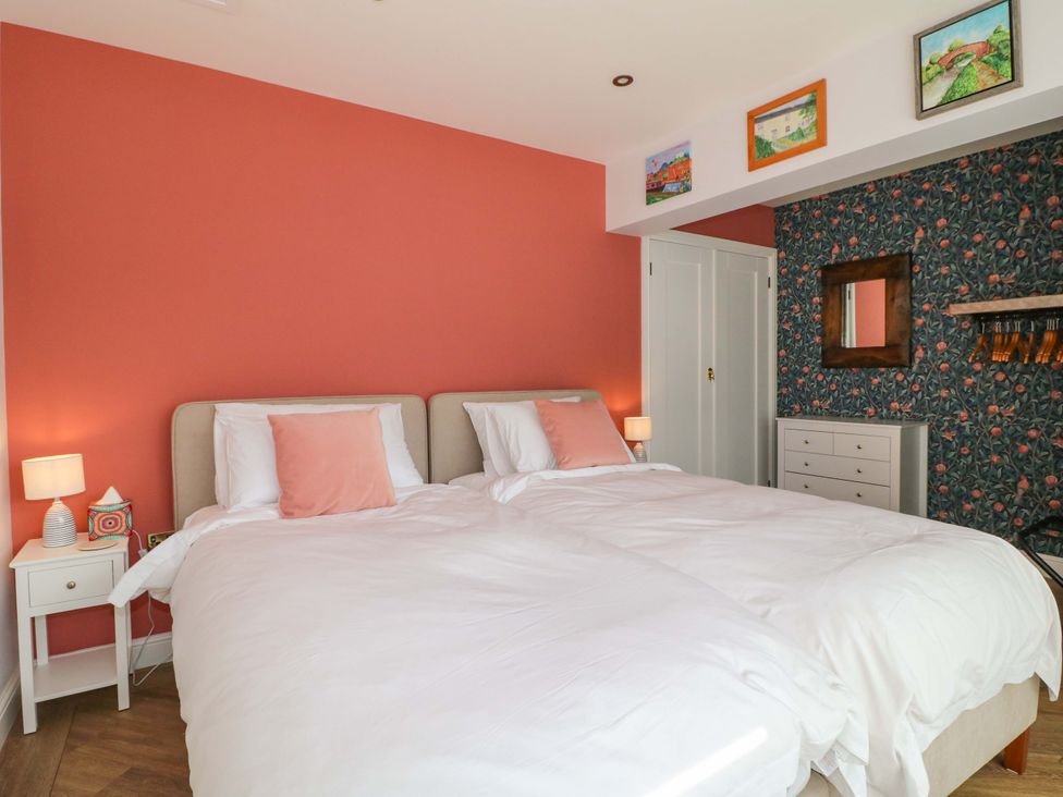 A bedroom with twin beds and decorative wall art at The Canalside Cottage in Derby