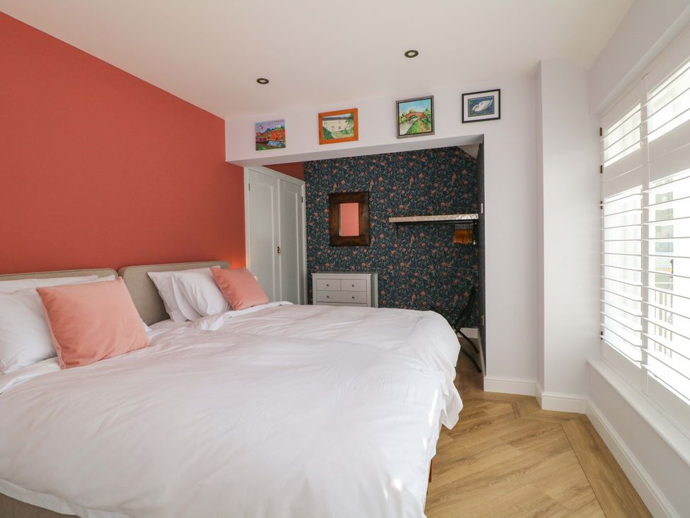 A bedroom with two beds and a dresser at The Canalside Cottage in Derby