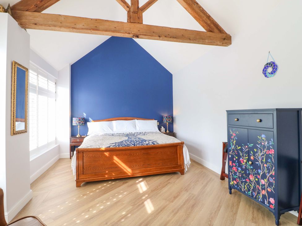 A bedroom with a bed and a dresser at The Canalside Cottage Derby
