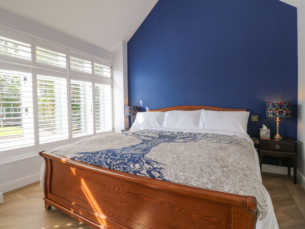 A bedroom with a bed and bedside table at The Canalside Cottage in Derby