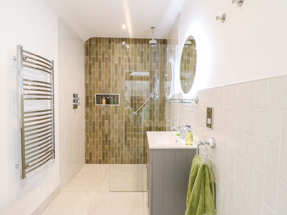 A bathroom with a shower and sink at The Canalside Cottage in Derby