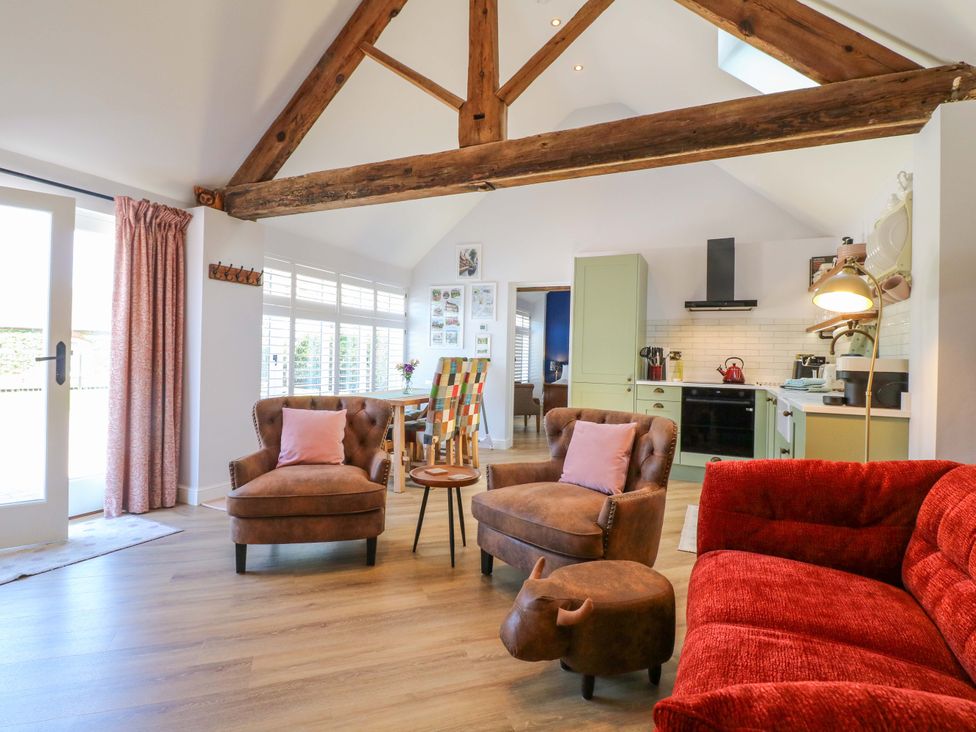 A living room with a sofa and armchairs at The Canalside Cottage in Shardlow near Castle Donington