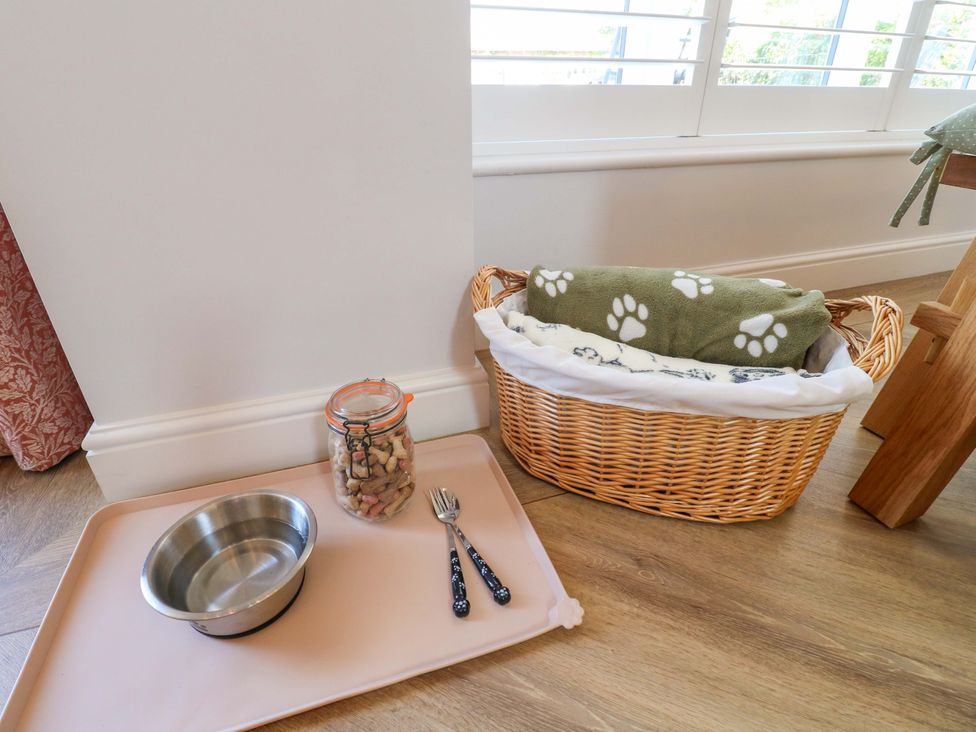 A dog feeding area with a bowl and treats at The Canalside Cottage in Shardlow near Castle Donington