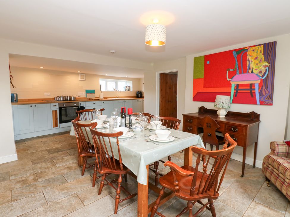 A dining room with a table set for a meal at Rosemary Cottage in Leyburn