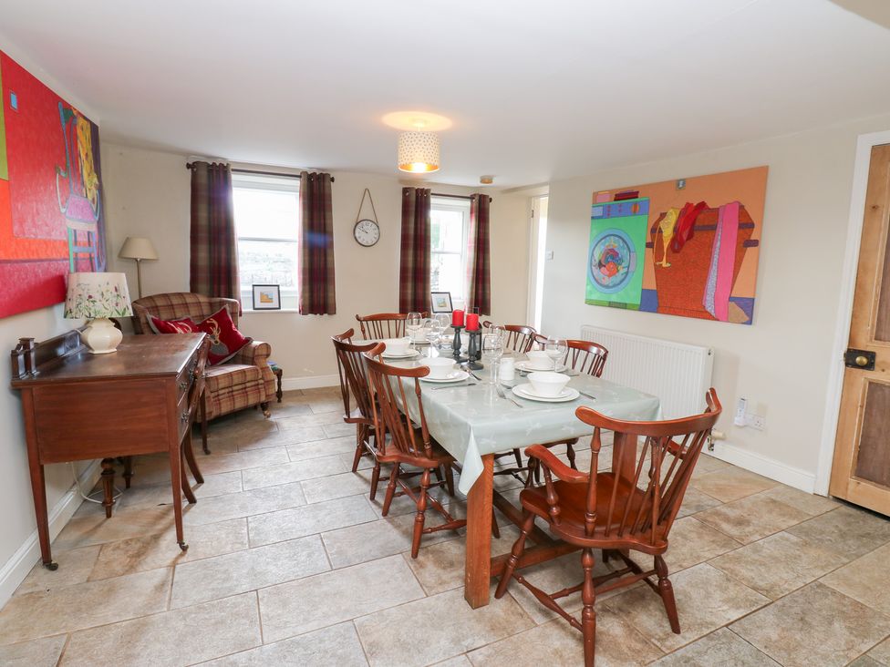 A dining room with a table set for dinner at Rosemary Cottage in Leyburn